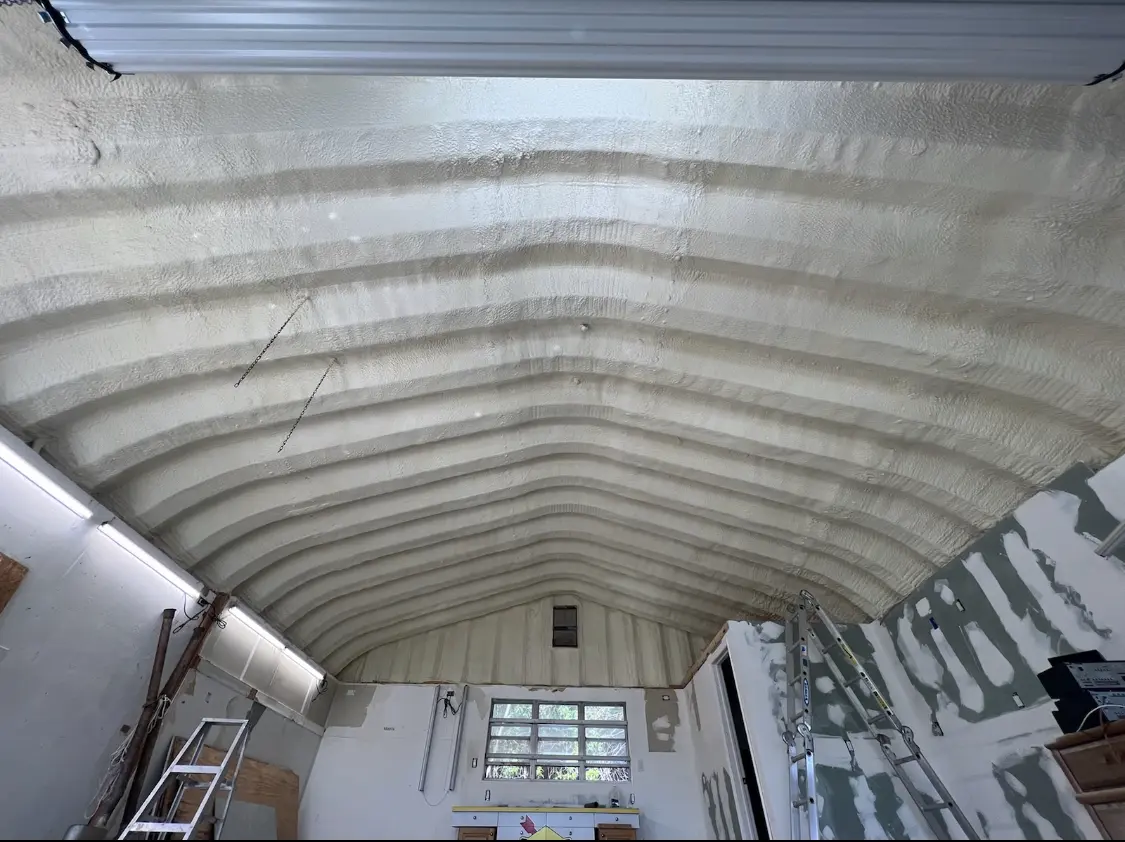 Spray polyurethane foam applied to the underside of a metal roof deck in Center